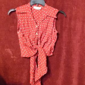 Sleeveless red and white polka dot shirt